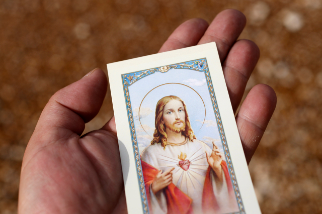 Devotion to the Sacred Heart of Jesus. Holy image in hand.
