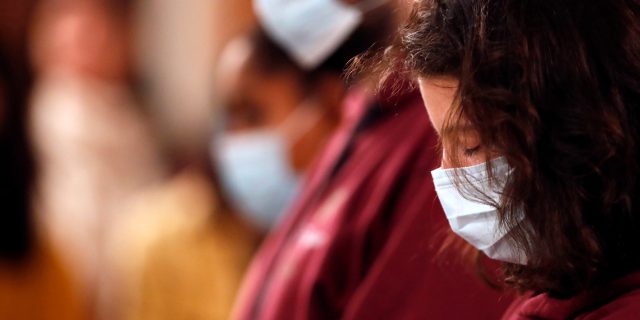 Basilica of Our Lady of Geneva. Christians wearing surgical mask at mass.