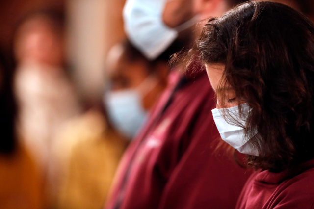 Basilica of Our Lady of Geneva. Christians wearing surgical mask at mass.