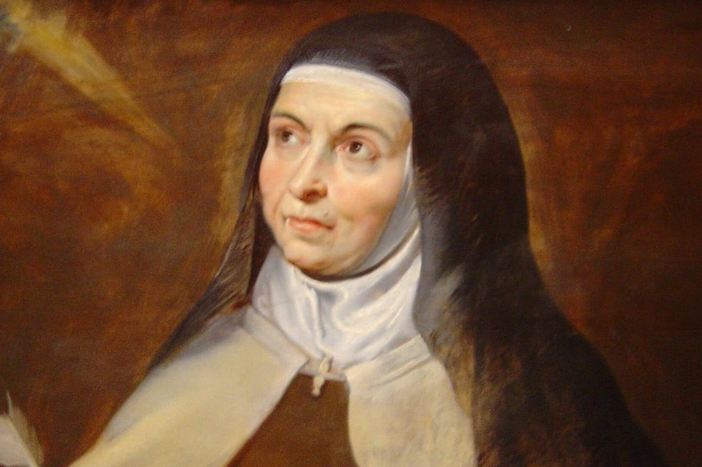 Teresa_of_Avila Santa Teresa D'Ávila segurando um livro e uma pena para escrever.