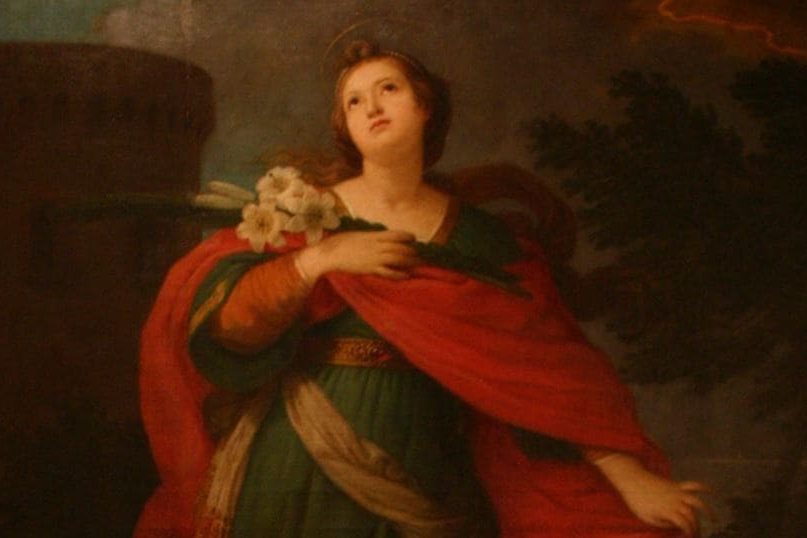 santa-barbara Santa Bárbara segurando buquê de flores e olhando para cima.